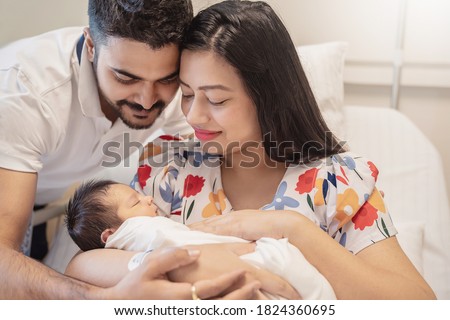 Portrait of Asian parents newborn baby day, Closeup portrait of asian young couple father mother holding new born baby in hospital bed. Happy asia lovely family, nursery breastfeeding mother’s day Royalty-Free Stock Photo #1824360695