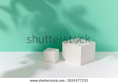 Abstract background mock up with podium for product display with shadows on turquoise. Blank product stand in minimal slyle. Royalty-Free Stock Photo #1824377210