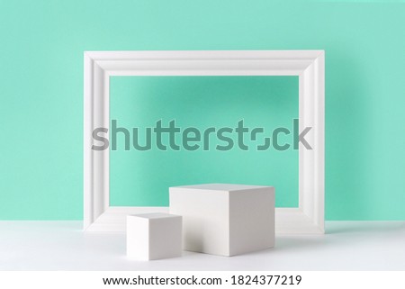 Mock up background with podium for product display and frame. Blank product stand in minimal slyle on turquoise background. Royalty-Free Stock Photo #1824377219