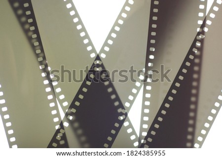 Photographic film background. 35mm negative film tapes on a white background. Analog/film photography background.