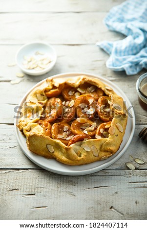 Homemade apricot galette with almond flakes 