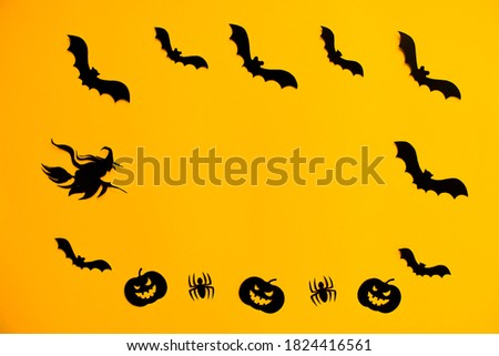Frame of paper silhouettes of bats, scary pumpkins, spiders and witch on broomstick on orange background. Treat or trick Halloween holiday banner template with copy space in the middle.