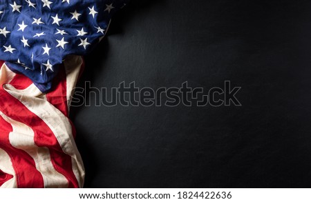 Happy Veterans Day concept. American flags against a blackboard background. November 11.