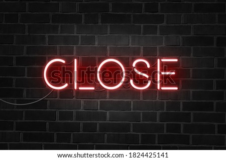 CLOSE red neon sign on brick wall