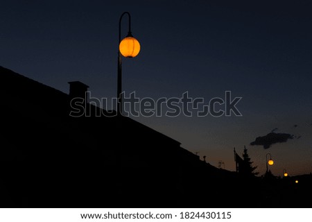 Yellow glowing lantern light over dark navy blue sky at night