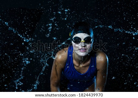 Caucasian Sportswoman in Swimsuit Posing in Aqua Studio Against Black. Horizontal Image