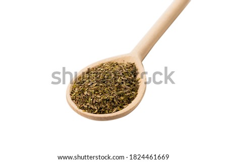 Oregano spice in wooden spoon isolated on white background. 
