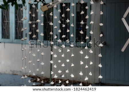 The shells are tied with ropes for a curtain