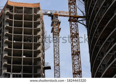 tower crane on the background of a house under construction