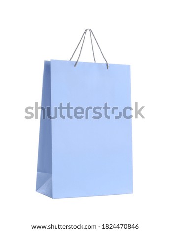 Light blue paper shopping bag isolated on white