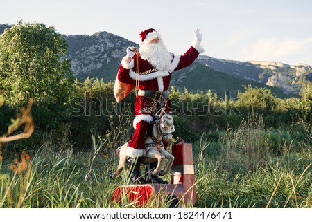 santa claus exchanges the reindeer for a coin operated toy, standing and waving
