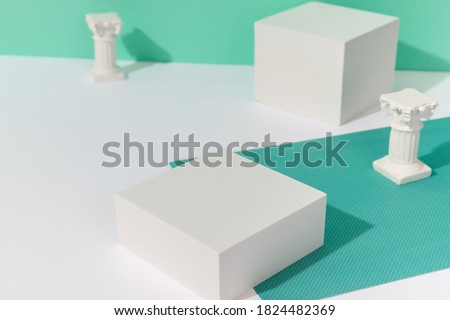 Abstract background mock up with podium for product display and gypsum ancient sculpture. Blank product stand in minimal slyle on turquoise background. Royalty-Free Stock Photo #1824482369