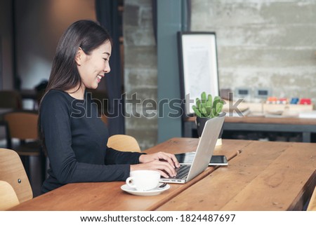 Businesswoman working online at the home office by laptop. Asian young entrepreneurs watching webinars and talking during meeting video conferences call with team, Female writing agendar on book.