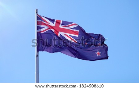 New Zealand flag flying on blue sky                               