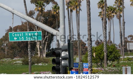 Pacific Coast Highway, historic route 101 road sign, tourist destination in California USA. Lettering on intersection signpost. Symbol of summertime travel along the ocean. All-American scenic hwy.