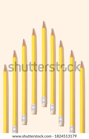 yellow pencil in a row on beige paper background and copy space for your text