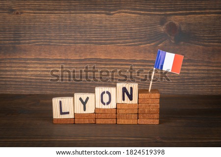 LYON. City in France. Steps and flag on a wooden background.