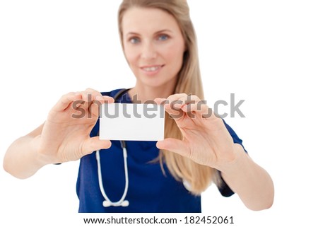 Portrait of a happy young Doctor holding a blank sheet of paper on white to write your text. Isolated on white background.