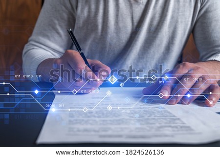 Double exposure of man signing papper and technology theme hologram. Blue infographic of high-tech. Concept - sign job contract.
