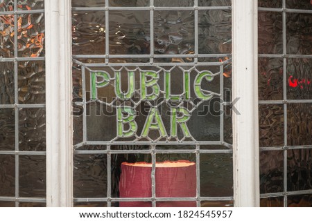 Leaded light window Public Bar sign in a British pub.