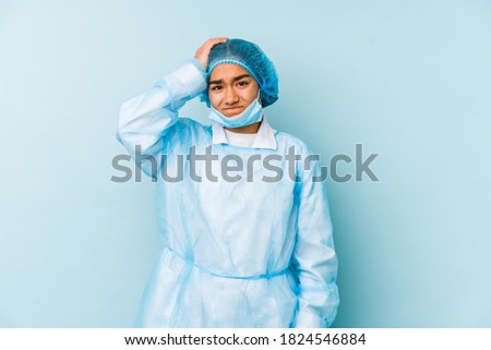 Young surgeon asian woman isolated being shocked, she has remembered important meeting.