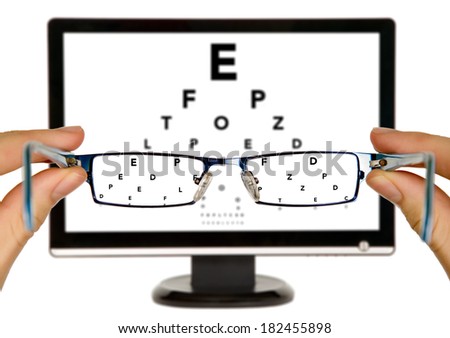 Man is viewing to eye examination chart on display through eyeglasses