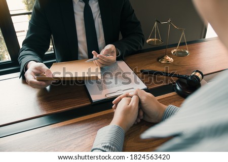 Clients come to seek advice for the law regarding privacy violations with the lawyer at the office. Royalty-Free Stock Photo #1824563420
