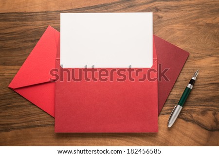 Blank paper, pen and envelopes on wooden background  