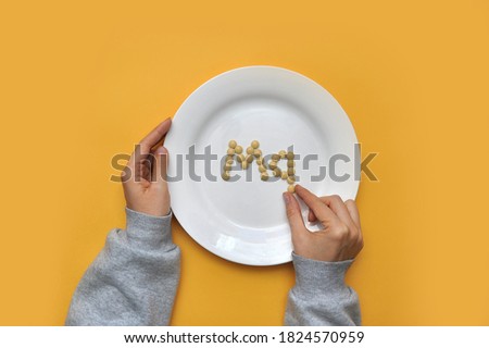 Sign of the trace element "magnesium" from tablets on a white plate. magnesium deficiency in the body Royalty-Free Stock Photo #1824570959