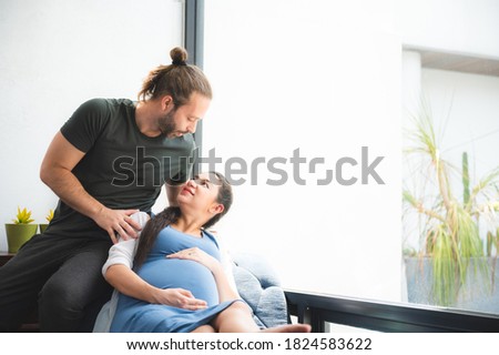 Young family pregnant wife and husband take care and spent time together