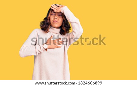 Young beautiful mixed race woman wearing winter turtleneck sweater touching forehead for illness and fever, flu and cold, virus sick 