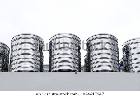 Rows of water tanks above the building