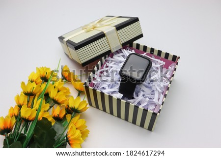 Photo of smart watch inside gift box. Isolated on white background.