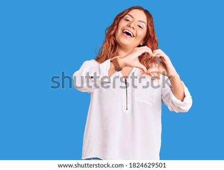 Young latin woman wearing casual clothes smiling in love doing heart symbol shape with hands. romantic concept. 