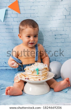Party for one year baby boy with a set composed of balloons, ribbons, and brick wall paper and pancakes.
