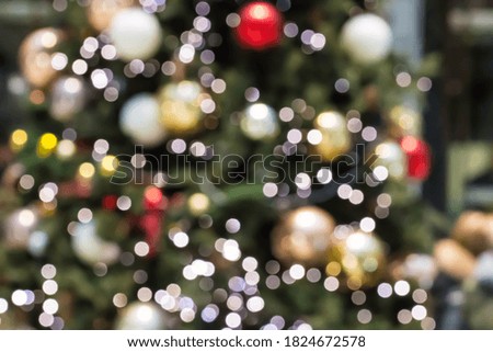 Christmas tree out of focus with glowing lights. Abstract blurred christmas background with defocused lights. Festive backdrop. Merry Christmas, Happy New Year holiday greeting card. Xmas decoration