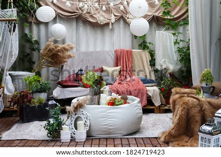 gazebo interior in folk style with pillows and coffee