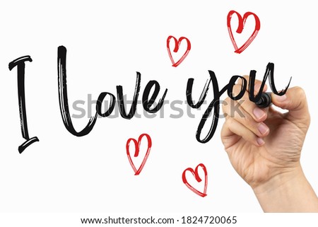 I love you with little hearts. Doodle  on a whiteboard, written with black marker in a hand. Scribble sketch text on a white board