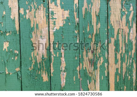 Dark green scratched grunge Wooden textured wall. Old wood texture with peeling paint.