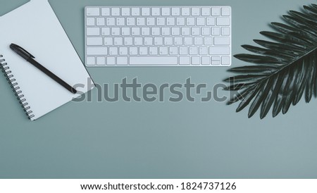 Workspace banner with laptop and spiral notebook, on pastel background, Flat lay of home office desk, Office concept.
