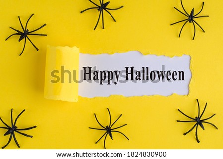 Top above overhead view photo of torn bright yellow paper over white background with decorative spiders