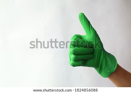 Hands in green surgical gloves.
Like sign icon made from green medical gloves. Hand thumb up symbol. Thumb up gesture. Isolated on white
