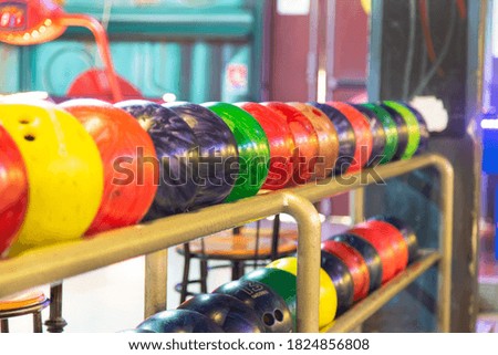 Bouwling ball of all colors arranged on the rail in the room