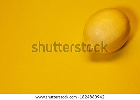 Fresh lemon placed on a yellow background, healthy