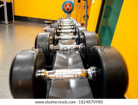 Dumbbells wrapped in rubber for more safety and ready to be used on the rack