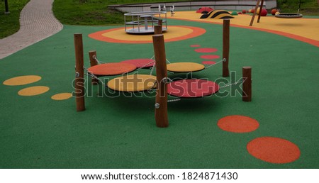 Children's playground, with a rubber multi-colored coating and interesting playgrounds. Royalty-Free Stock Photo #1824871430