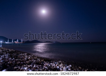 Moon over sea boat mountain