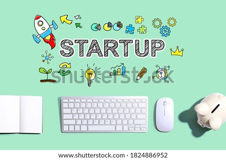 Startup with a computer keyboard and a piggy bank
