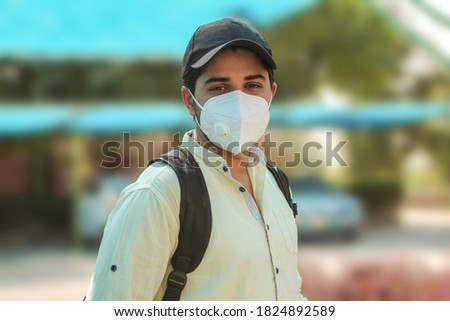 College student wearing N-95 mask for corona protection portrait Royalty-Free Stock Photo #1824892589