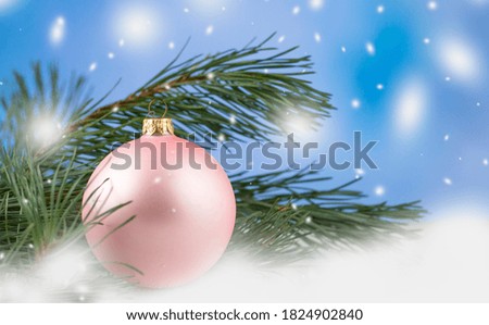 Christmas. New Year's and Christmas. Christmas card background. Pink ball and branches of a Christmas tree. Snow. copyspace